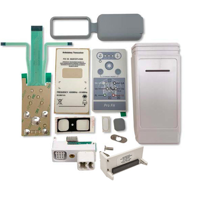 This image features a comprehensive view of the GE ApexPro FH Case Assembly Kit, displaying a variety of components essential for the system's operation. The kit includes a wall-mounted fire alarm control panel in gray, complete with a digital display and multiple buttons for different functions.