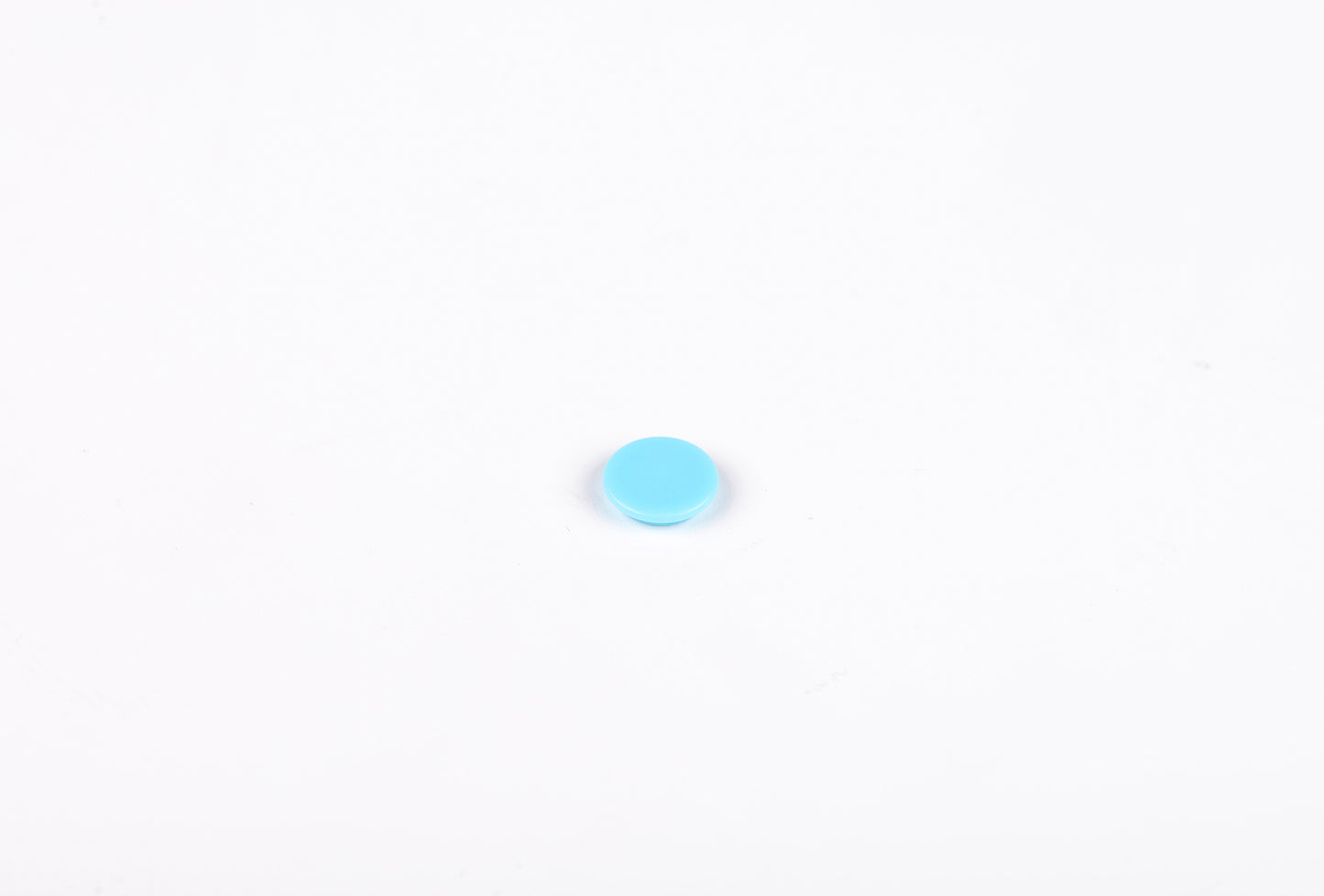 Small blue circle on a white background