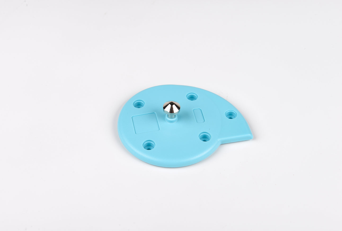 Blue plastic component with a central metallic ball on a white background