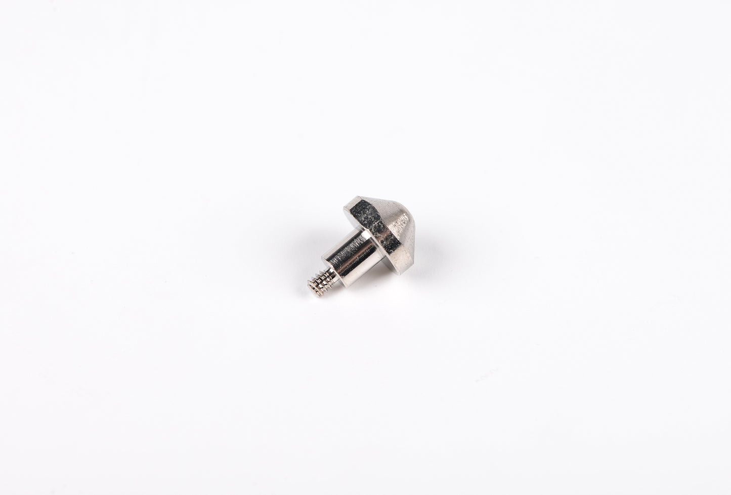 Small metallic object on a white background