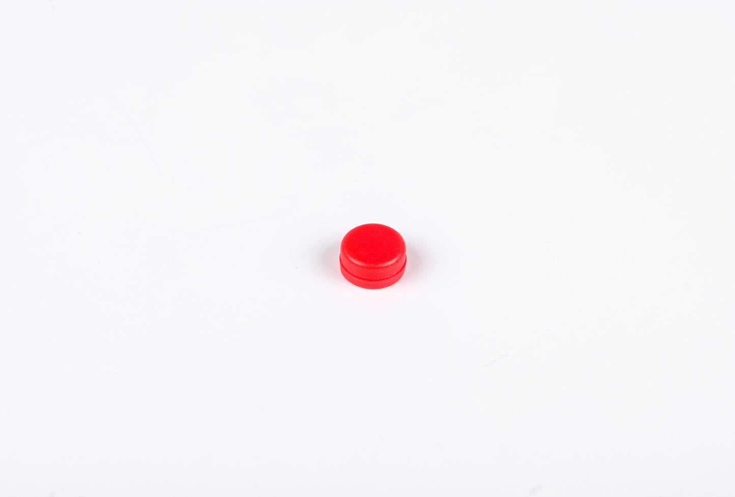 Small red object on a white background