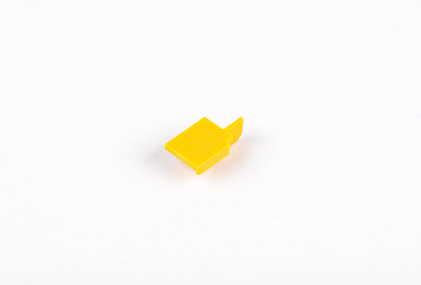Yellow plastic component on a white background