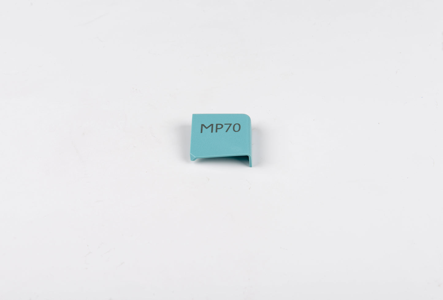 Small blue rectangular object with 'MP70' text on a light gray background