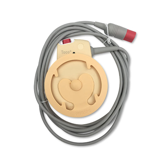 A fetal Toco transducer with a grey cable and red connector, primarily beige in color with the brand name 'Avalon' visible.