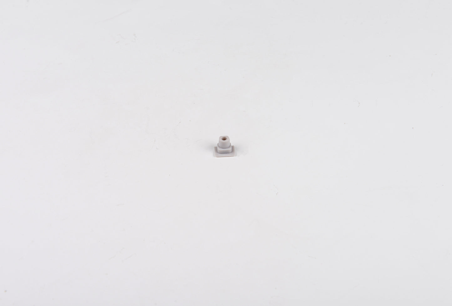 Small metallic object on a white background