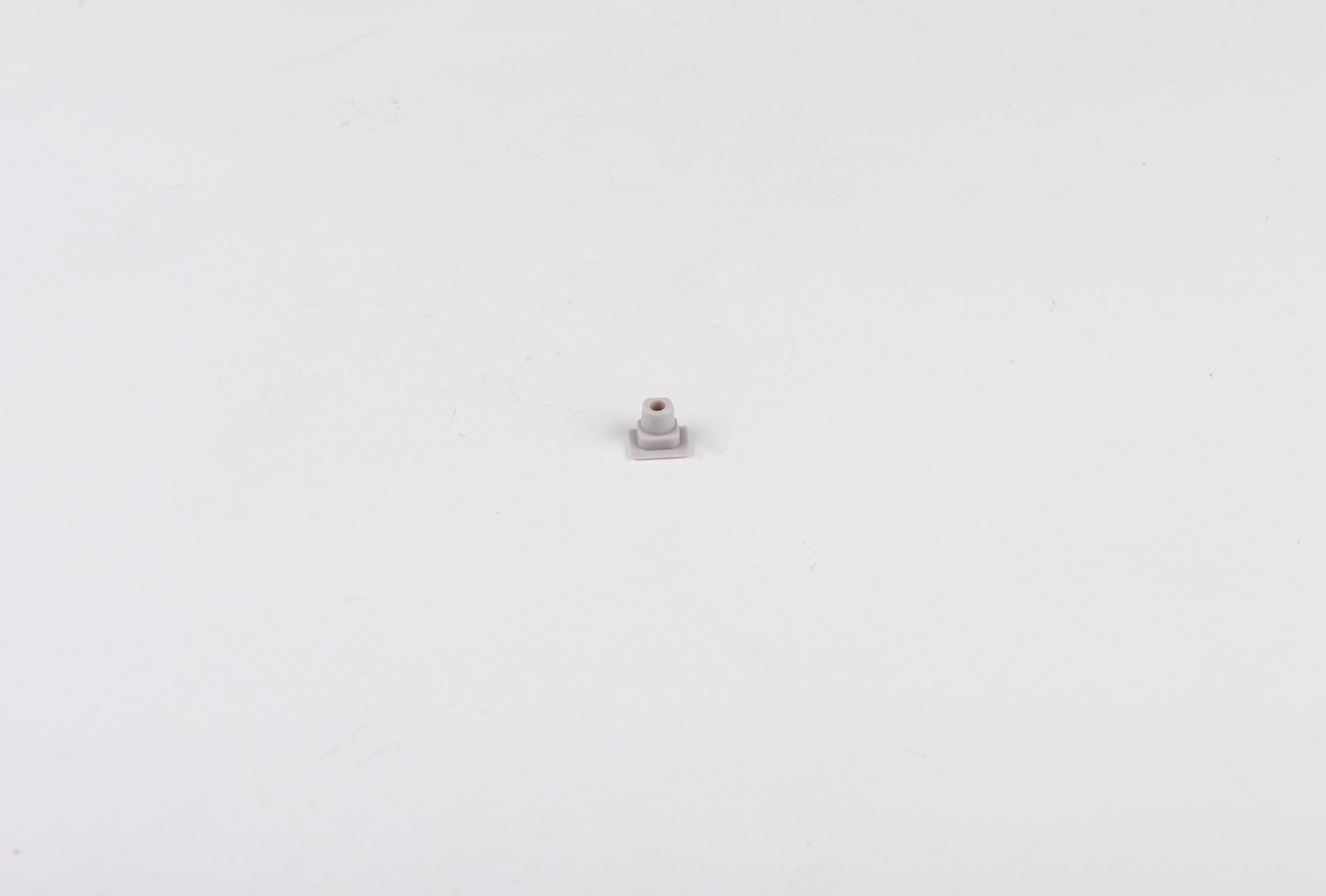 Small metallic object on a white background