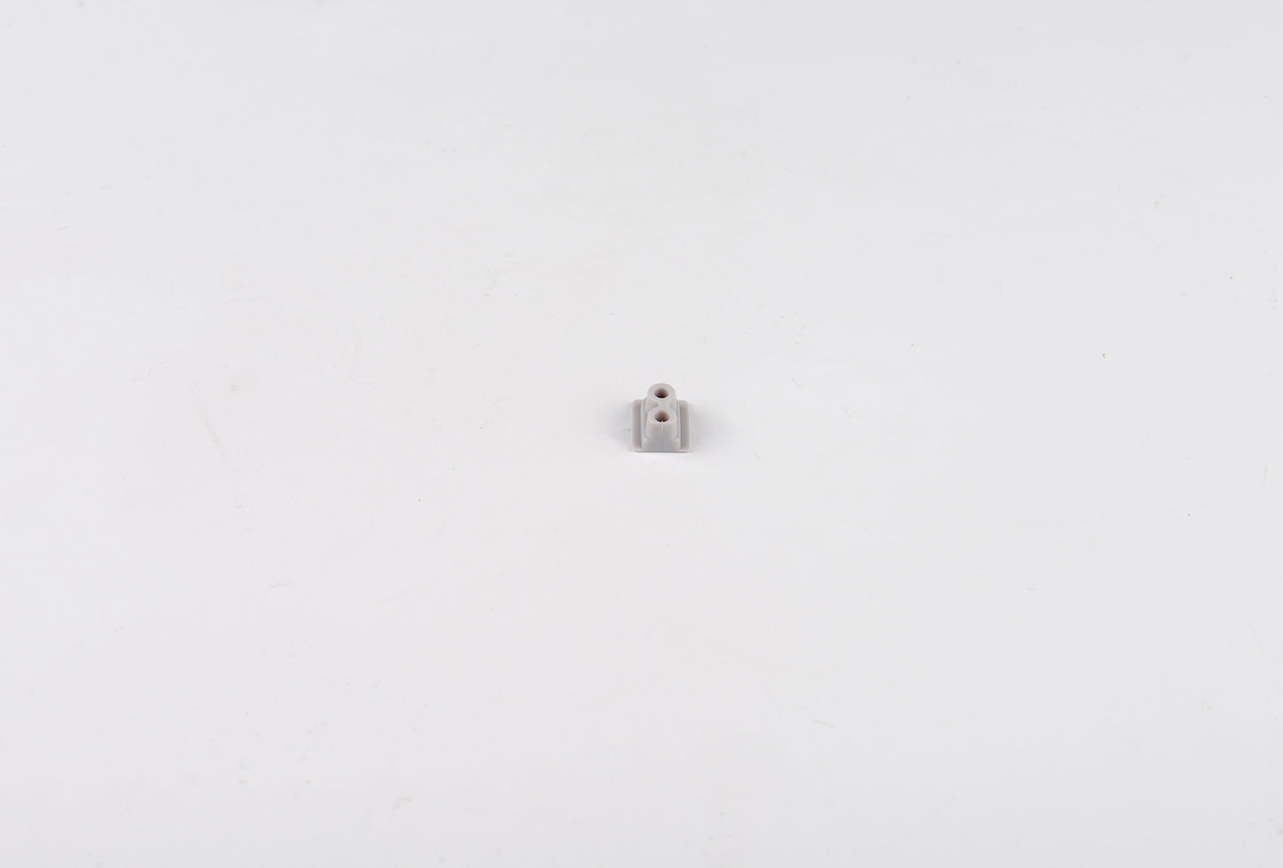 Small metallic object on a white background