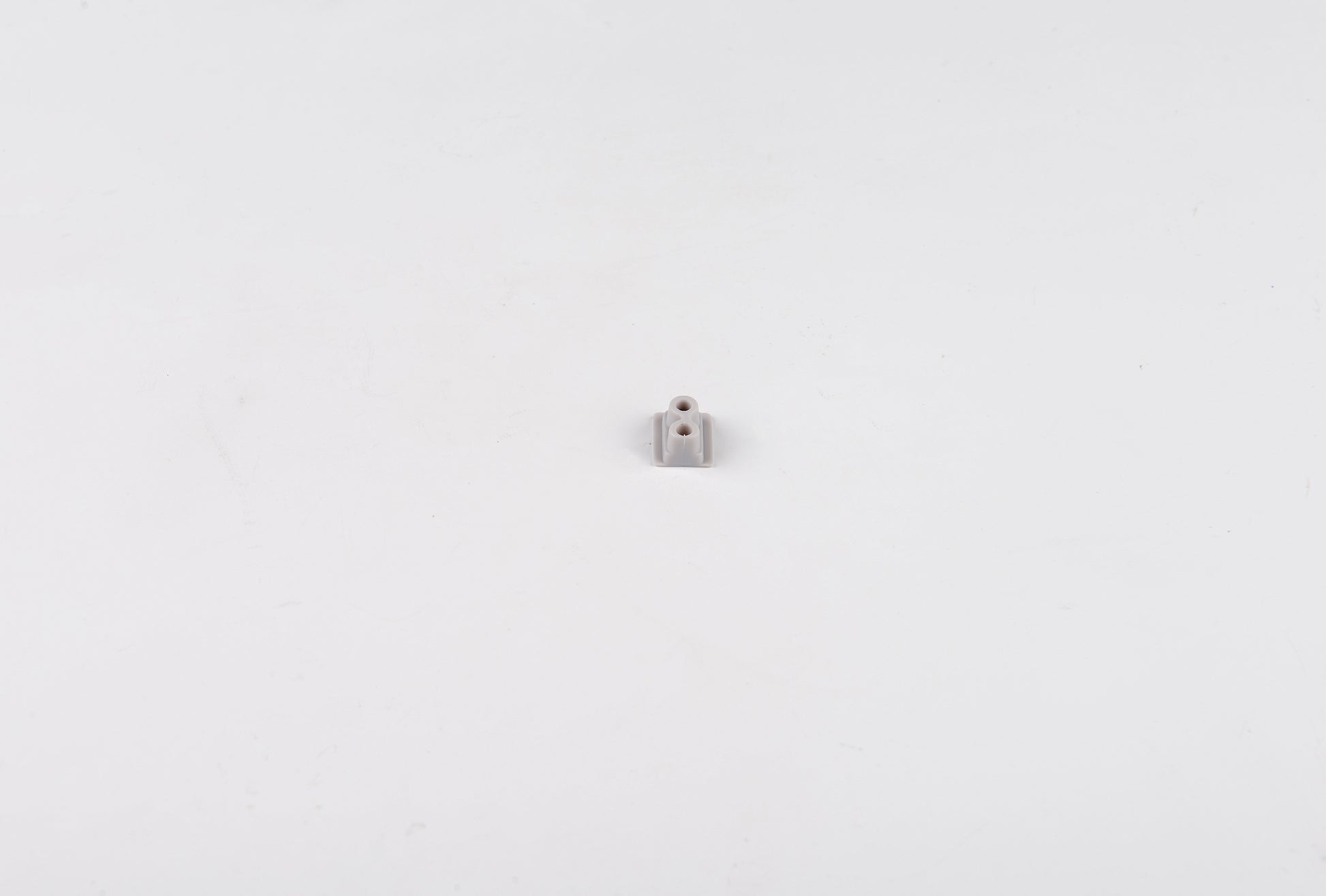 Small metallic object on a white background