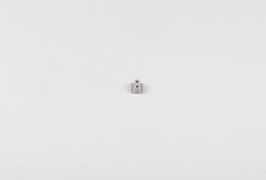 Small metallic object on a white background