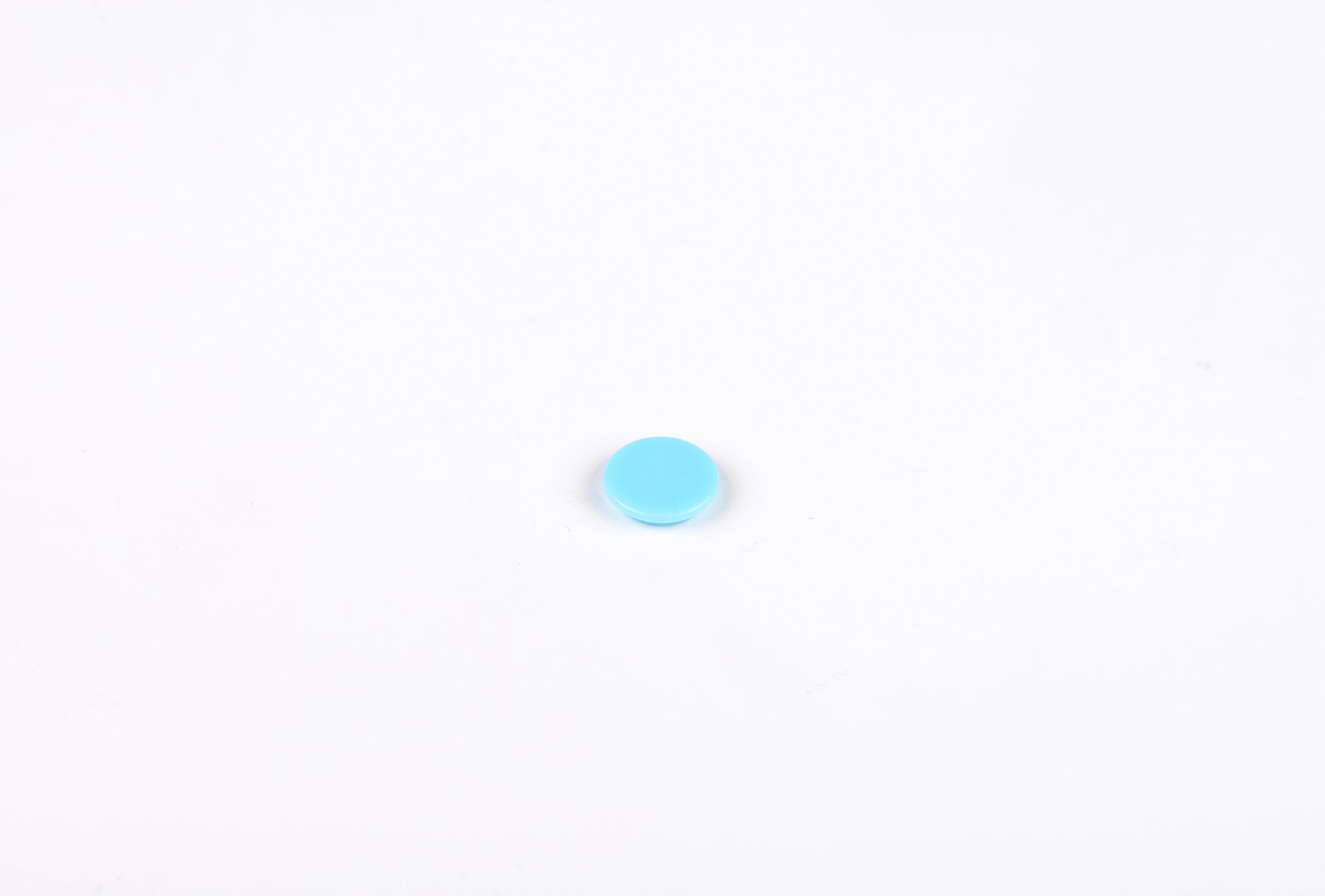 Small blue circle on a white background