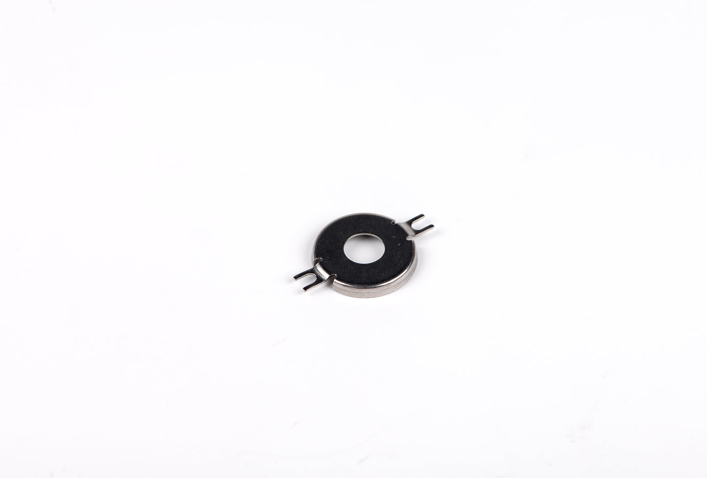 Small metallic component on a white background