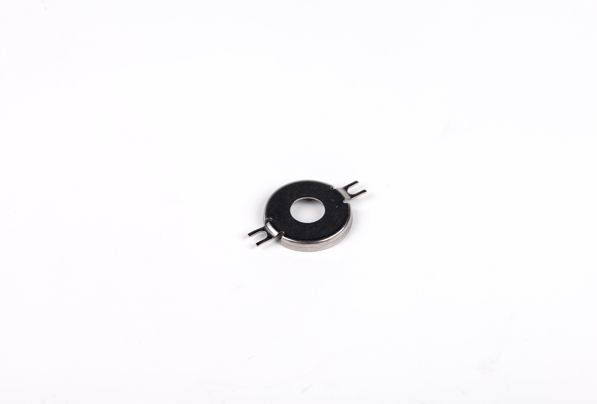 Small metallic component on a white background