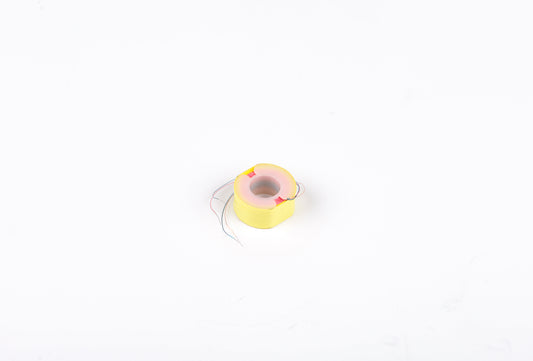 Small yellow and pink toy on a white background