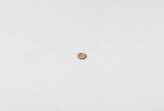 Small round object with a face design on a white background