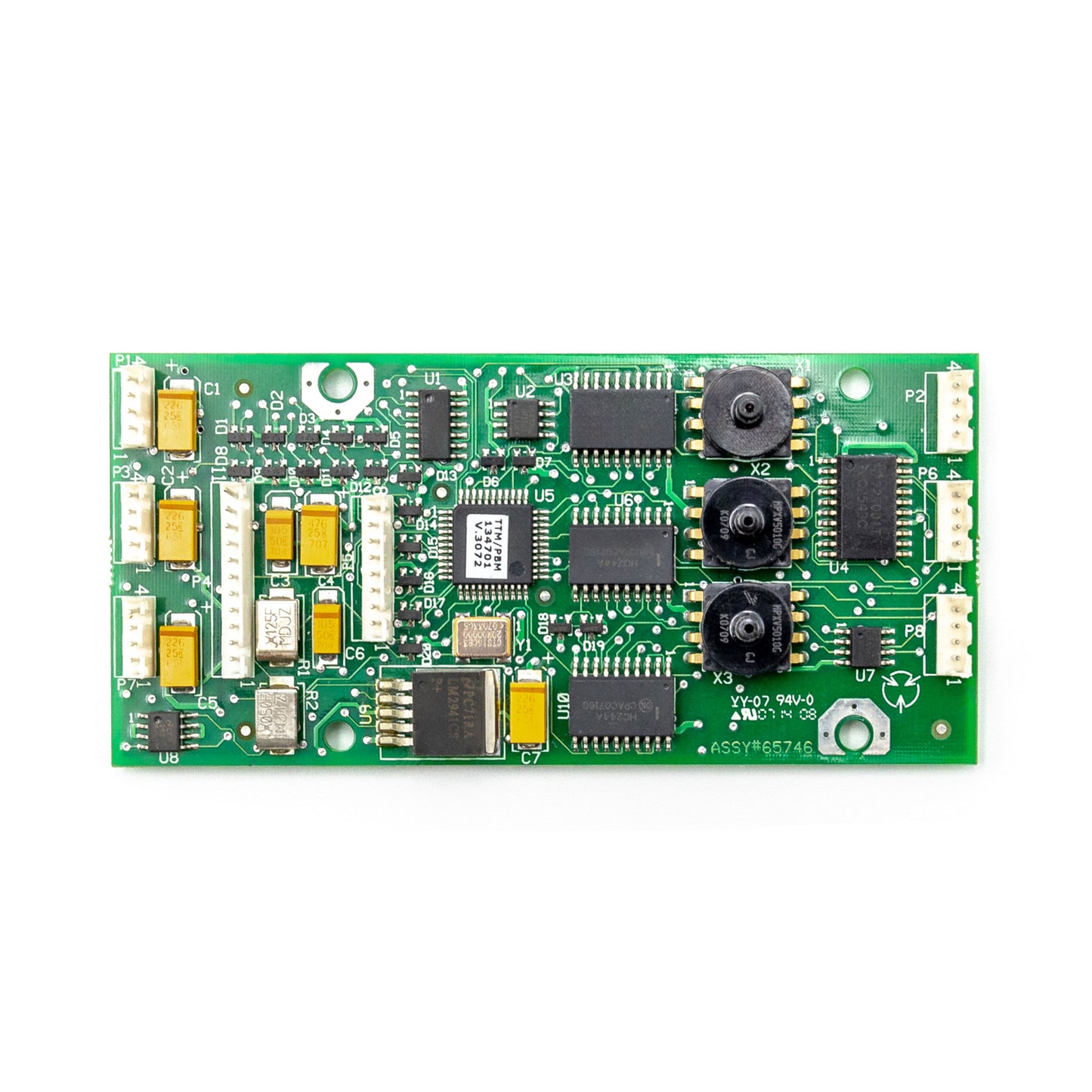 A green circuit board with various electronic components including integrated circuits, resistors, and connectors.