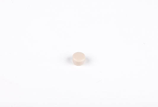 Small beige round object on a white background
