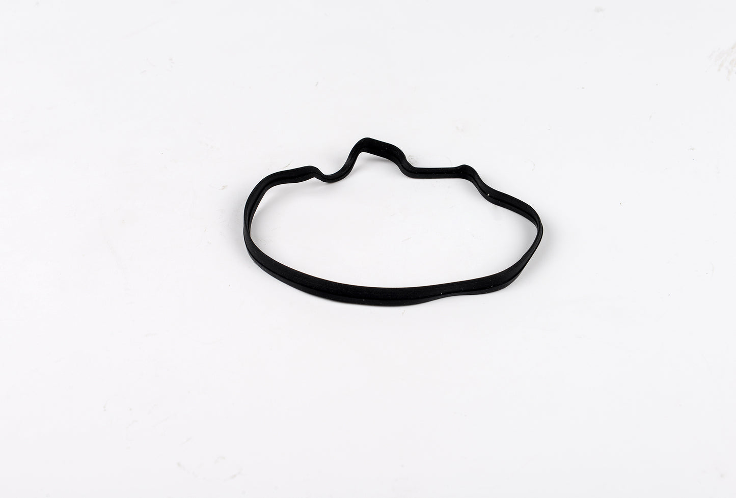 Black rubber gasket on a white background
