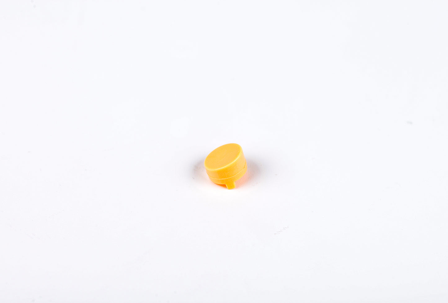 Small yellow object on a white background