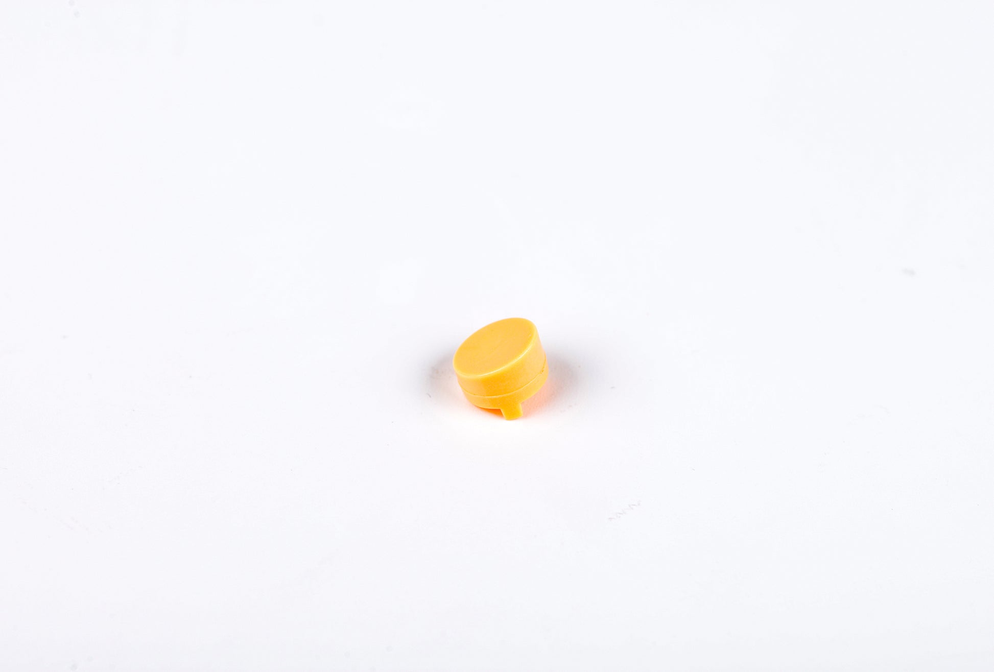 Small yellow object on a white background