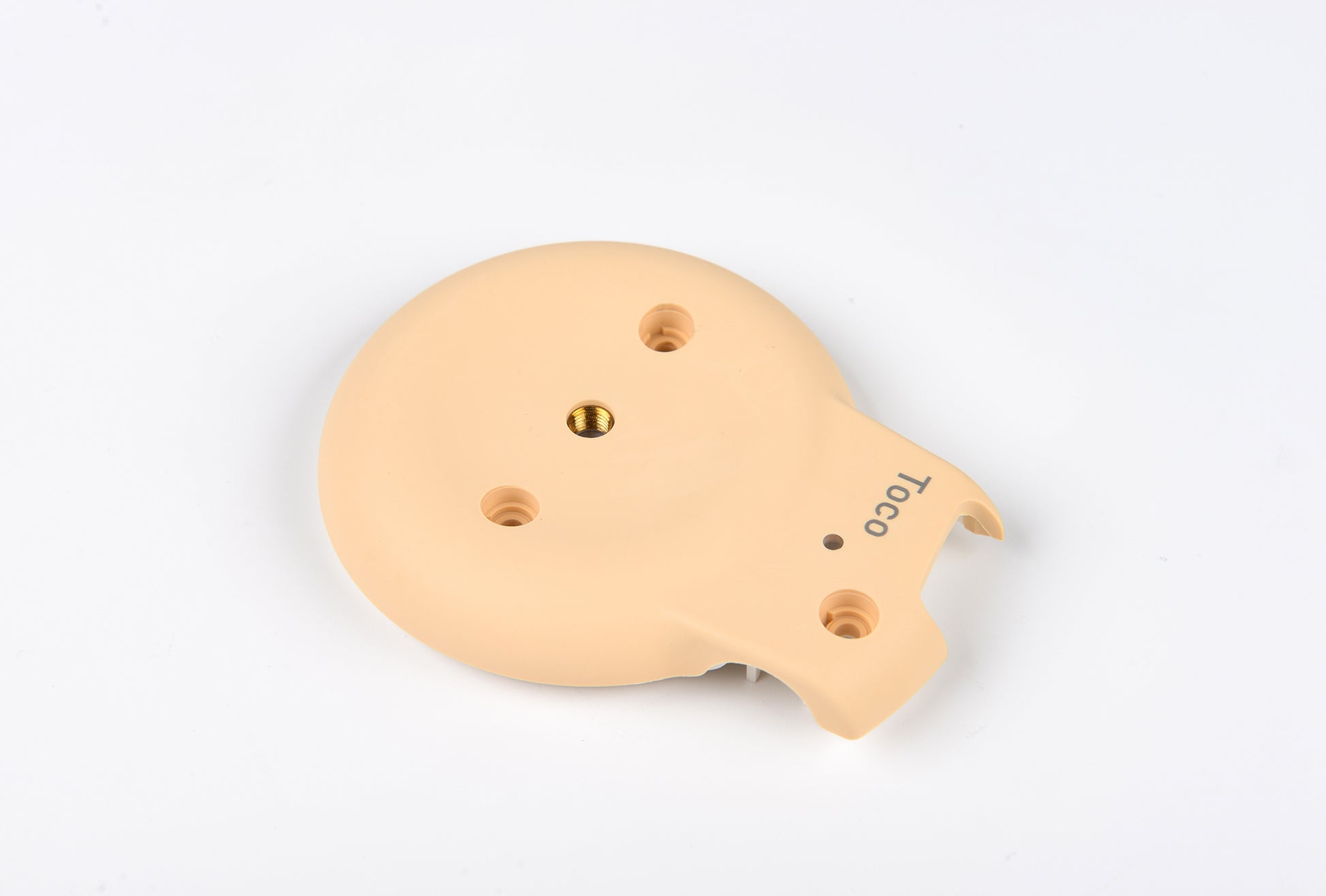 Beige plastic component with holes on a white background