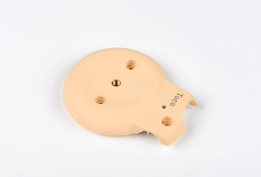 Beige plastic component with holes on a white background