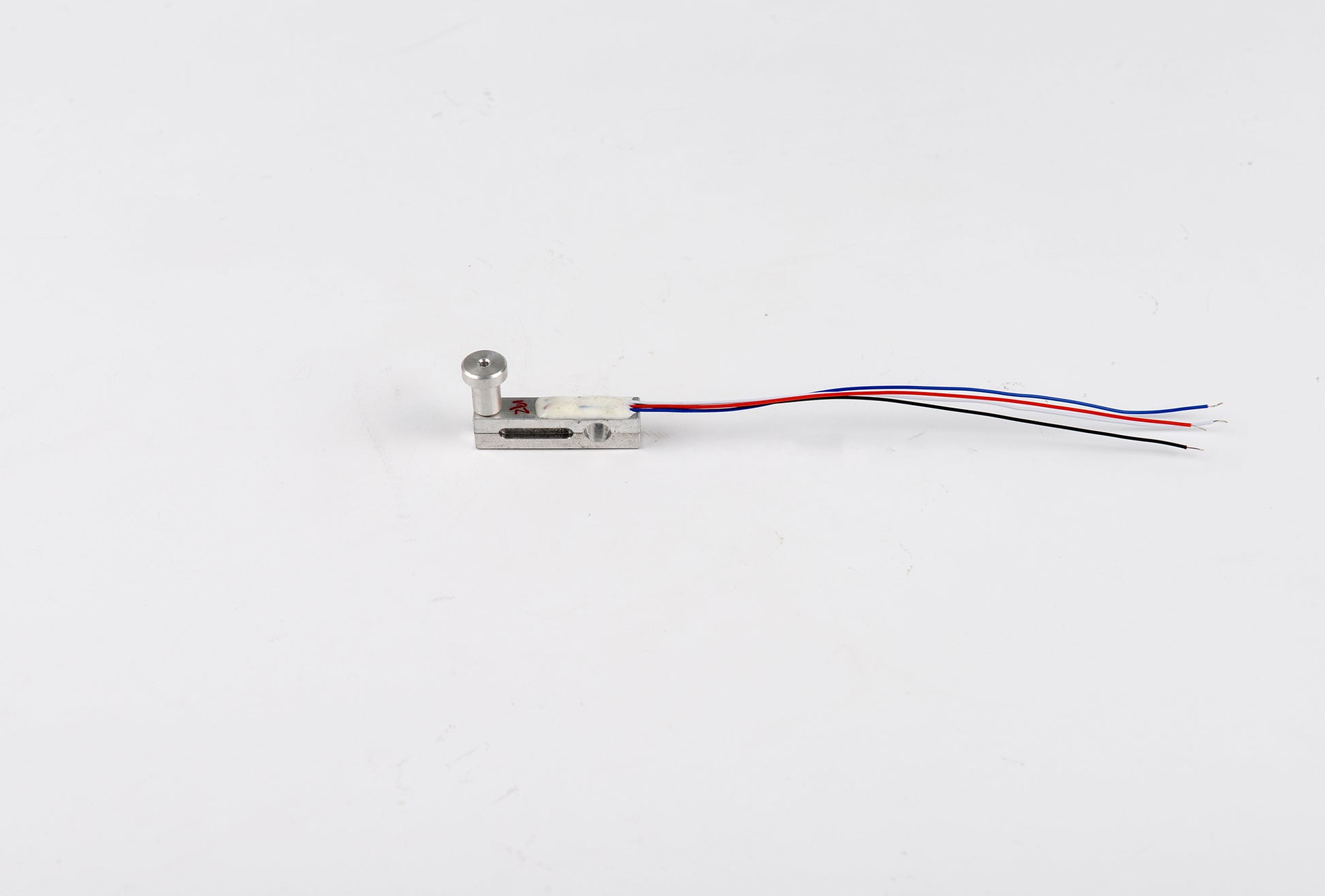 Small electronic component with wires on a white background