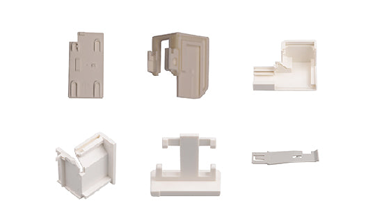 Set of white plastic brackets and clips on a white background