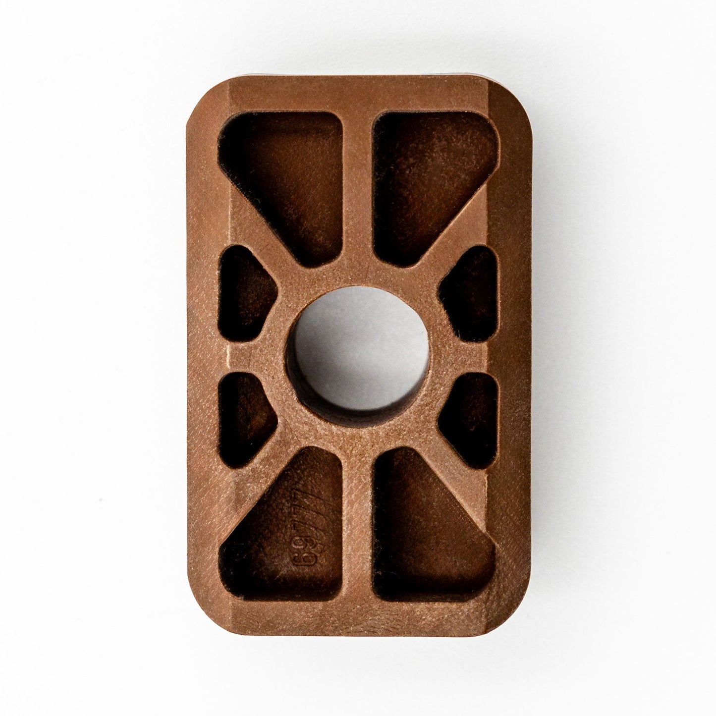 A brown Hillrom compatible slide for a VersaCare bed, showing a top view with multiple cut-outs and a central hole.