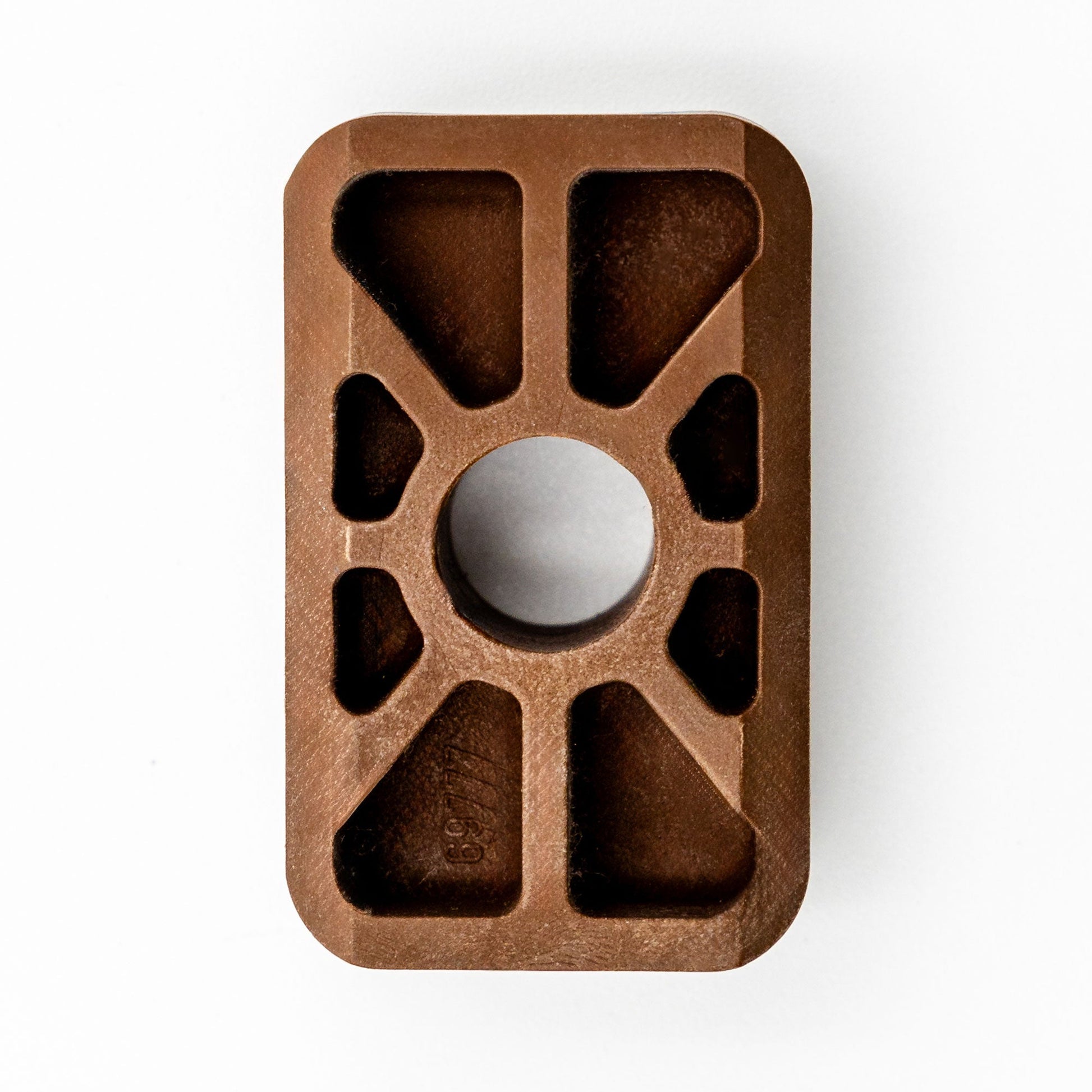 A brown Hillrom compatible slide for a VersaCare bed, showing a top view with multiple cut-outs and a central hole.