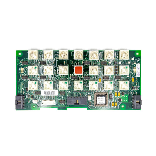 A green circuit board with various electronic components including integrated circuits, resistors, and connectors.